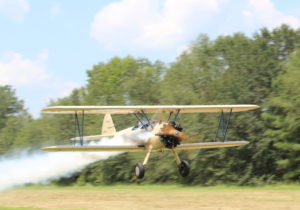 Flight school Stearman Low pass with smoke on